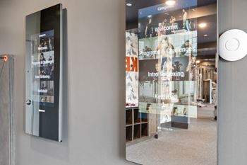 Cardio and strength training fitness center with eschelon and peloton bikes and fitness mirrors
